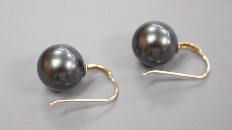 A modern pair of 585 yellow metal and Tahitian style South Sea pearl earrings, diameter approx. 11.8mm and 12.1mm, gross weight 5.9 grams.